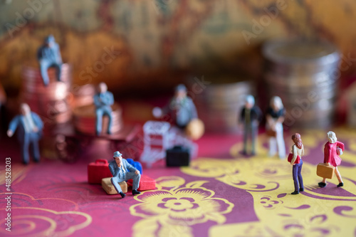 Miniature : group of businessmen standing back with coins and a vintage background.
