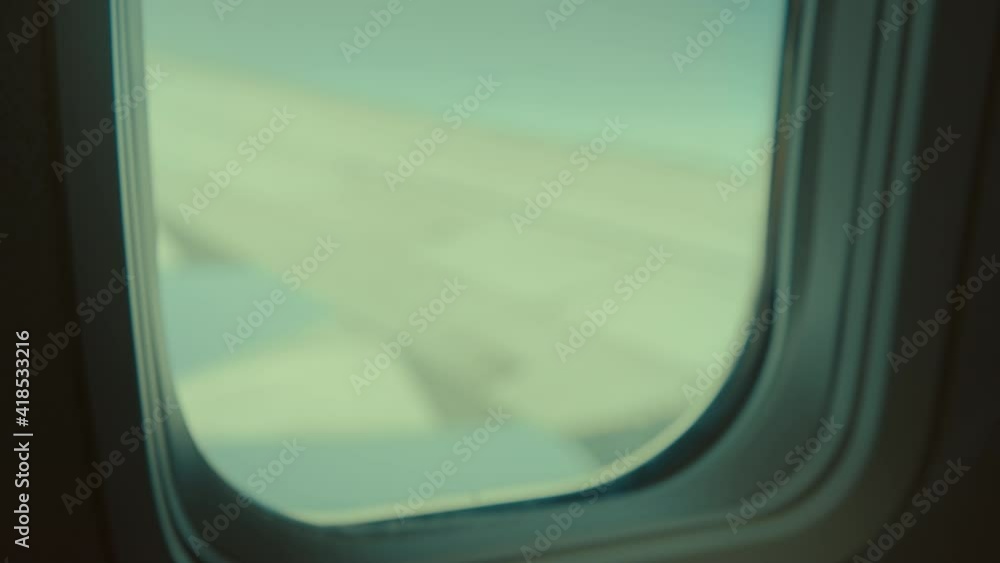 Young adult or child play with paper plane inside an aircraft. Flying inspiration, travel destinations wanderlust Young adult or child play with paper plane inside an aircraft. Flying inspiration, travel destinations wanderlust
