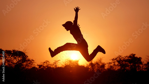 Man Jump with joy silhouette time of sunset