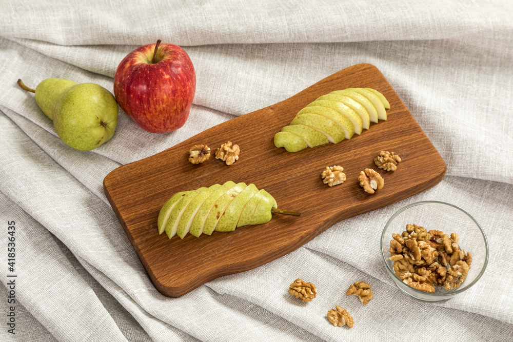 Fresh sliced pear on a wooden cutting board
