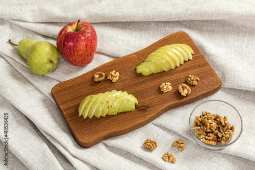 Fresh sliced pear on a wooden cutting board