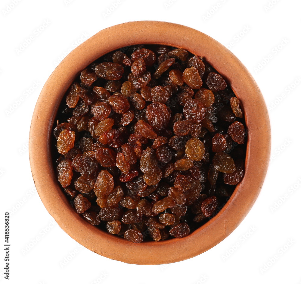 Raisins in clay pot isolated on white background, top view Raisins in clay pot isolated on white background, top view