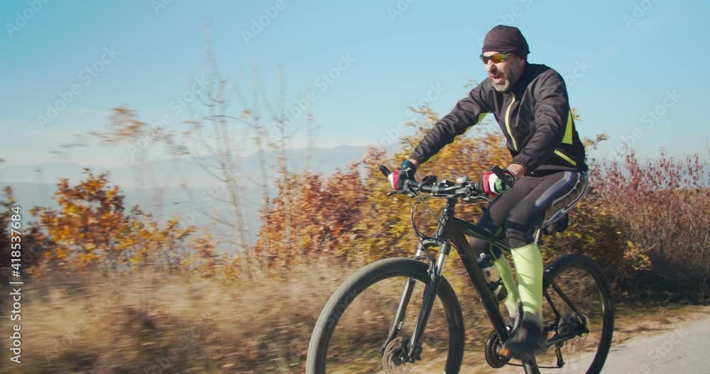 Man riding a bike trough the forest Man riding a bike trough the forest