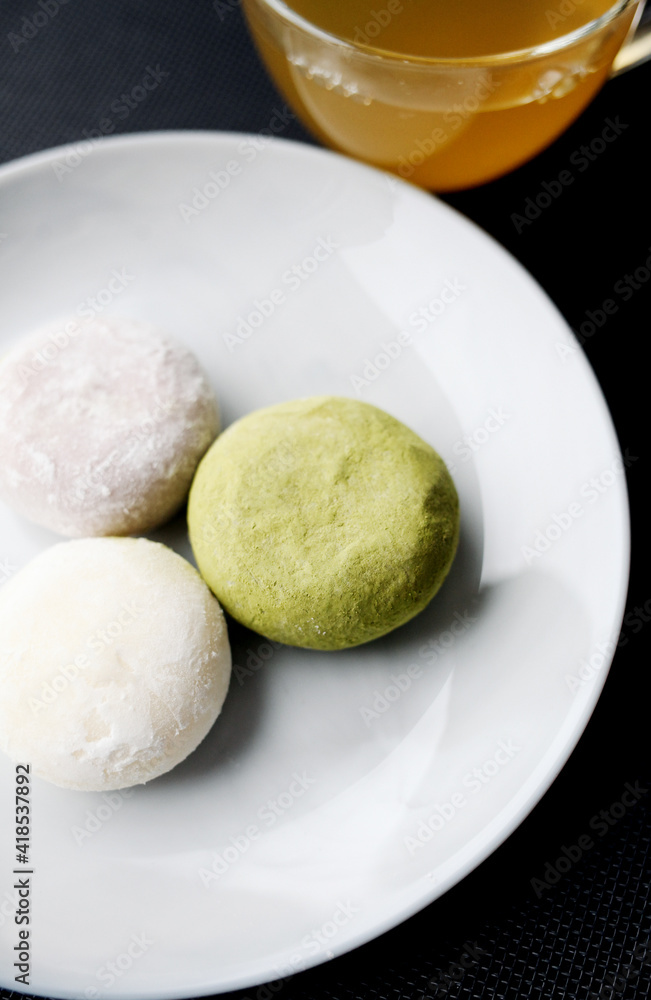 Japanese ice cream Mochi in rice dough. Traditional Japanese dessert on a black slate Japanese ice cream Mochi in rice dough. Traditional Japanese dessert on a black slate