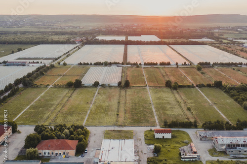 Aerial top view of greenhouse plant. Agronomy, year-round climate control and yield, indoor farming, heat recovery, power consumption and organic plant protection concept. photo