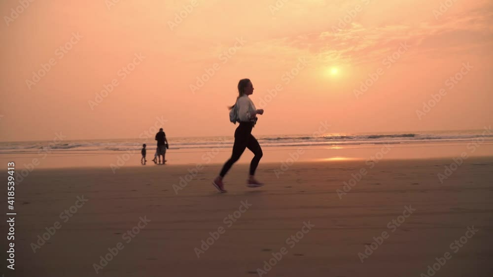 Woman is running on the Indian beach Woman is running on the Indian beach