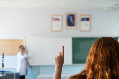Girl student asking to speak in the lesson