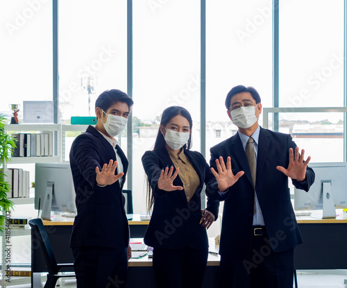 Business workers wear masks to protect and take care of their health.group asia business doing stop sing with palm of the hand © anusak