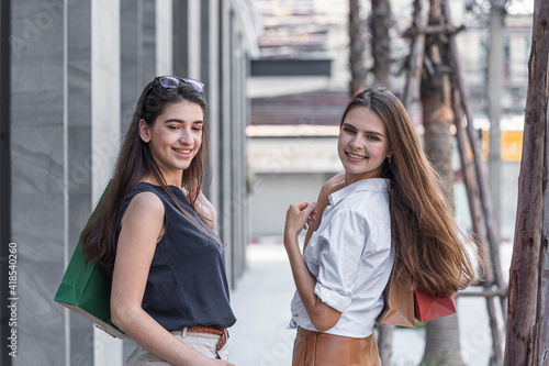 Wallpaper Mural Young shopaholic friends women friends walking and carry shopping bags in the street city with happy and smiling. Torontodigital.ca