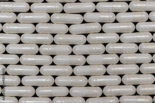 Background of medicines in the form of capsules lined in a brick style