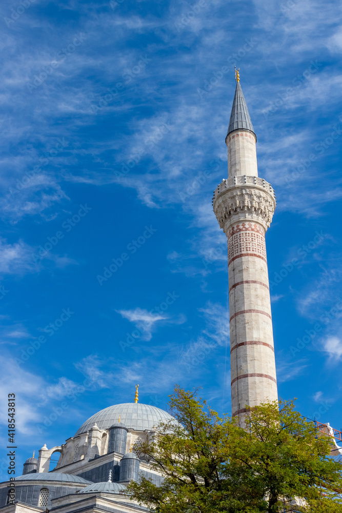 Minaret and the dome of the Bayezid II Mosque against the blue sky in Istanbul, Turkey