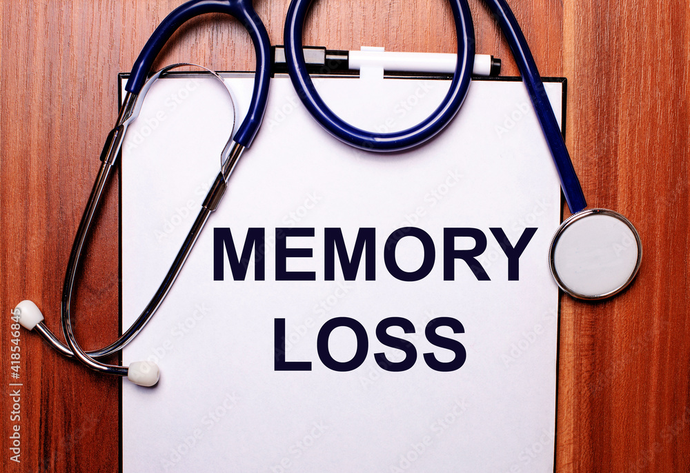 On a wooden background lies a stethoscope and a sheet of paper with the inscription MEMORY LOSS. Flat lay. Medical concept On a wooden background lies a stethoscope and a sheet of paper with the inscription MEMORY LOSS. Flat lay. Medical concept