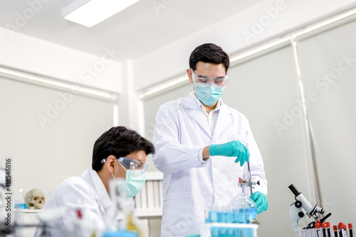 A medical team with a Stecoscope and wearing protective masks in a chemical laboratory