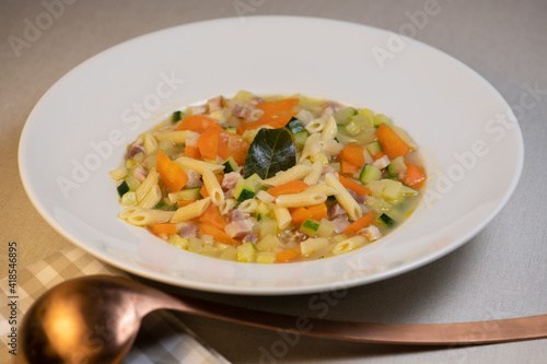 Fresh Vegetable soup and pasta in a white bowl , France