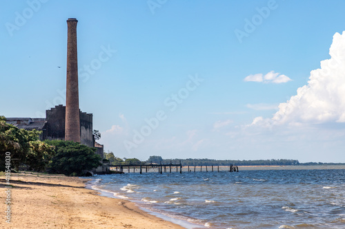 Beach with ruins of a old factory