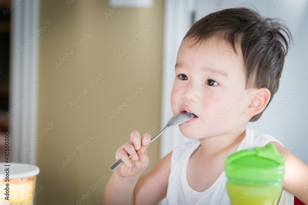Cute Young Chinese and Caucasian Boy Enjoying Eating His Ice Cream Cute Young Chinese and Caucasian Boy Enjoying Eating His Ice Cream