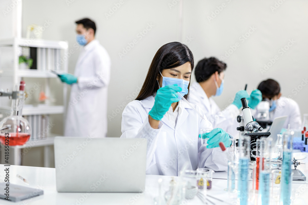 Chemists and laboratory equipment and a team of scientists. Chemists and laboratory equipment and a team of scientists.