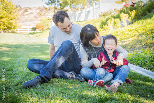 Happy Mixed Race Family Having Fun Outside on the Grass © Andy Dean