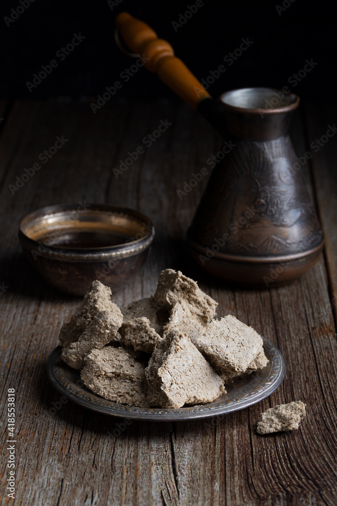 Fototapeta premium Vegetable-based halva sweet prepared from seeds on wooden background
