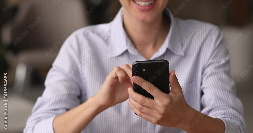 Close up addicted to modern technology smiling young businesswoman typing message on cellphone, enjoying using mobile software application, web surfing, shopping on communicating in social networks. Close up addicted to modern technology smiling young businesswoman typing message on cellphone, enjoying using mobile software application, web surfing, shopping on communicating in social networks.