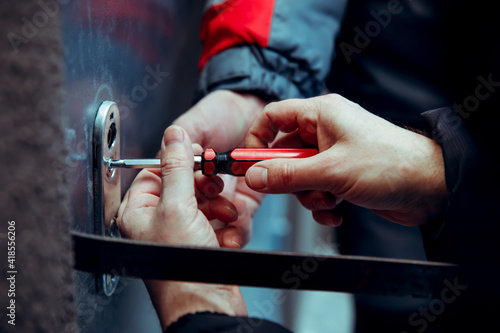 The cracker breaks open the steel door with lock picks improvised tools.