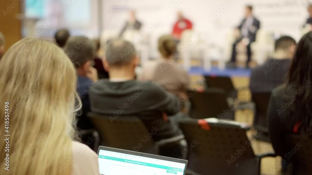 A woman attends a business presentation. A woman attends a business presentation.