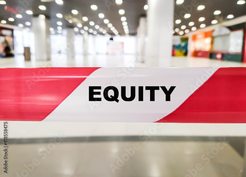The word - EQUITY on the red boundary tape indoors