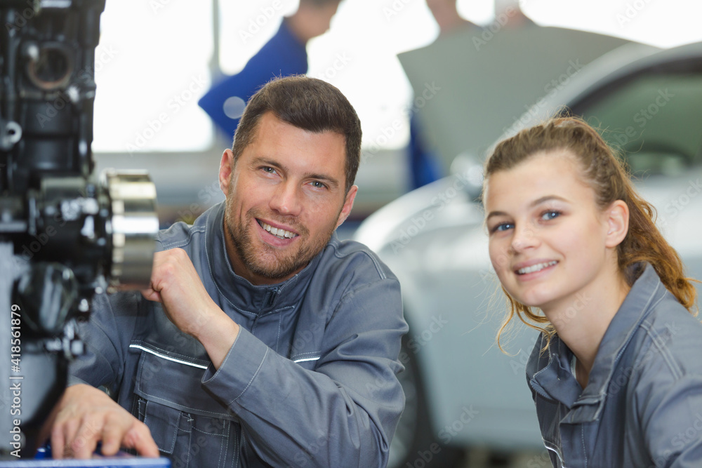portrait of mechanic with female apprentice