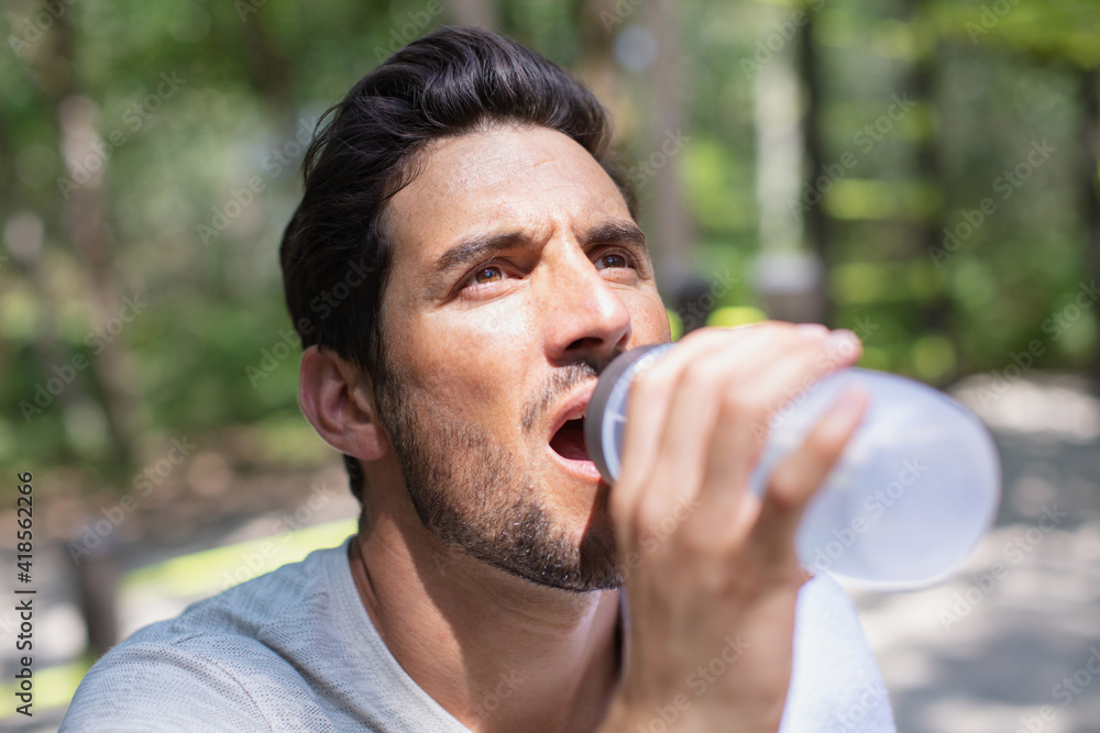 handsome man drinking water on a sunny day handsome man drinking water on a sunny day
