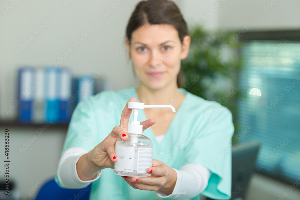 nurse showing alcohol gel pumper nurse showing alcohol gel pumper