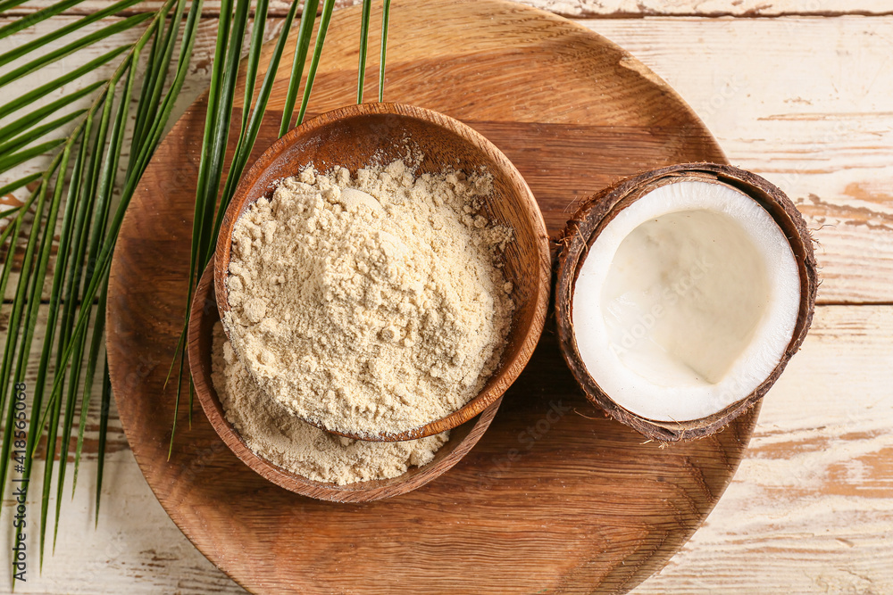Bowls with coconut flour on wooden background Bowls with coconut flour on wooden background