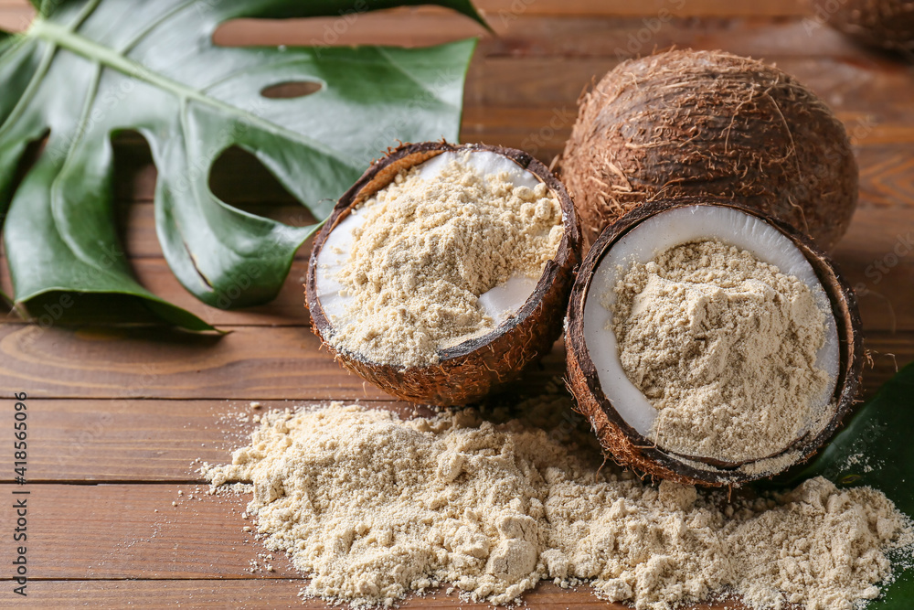 Coconut with flour on wooden background