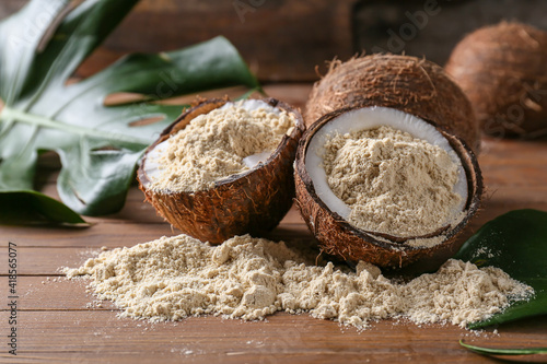 Coconut with flour on wooden background