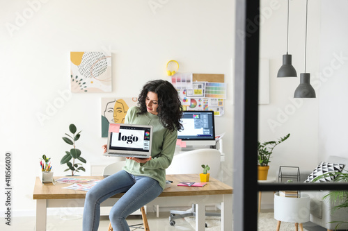 Young female designer worki...