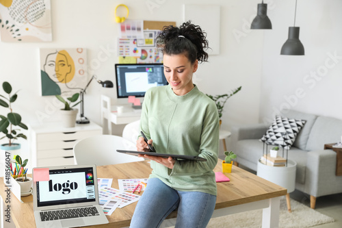 Young female designer worki...