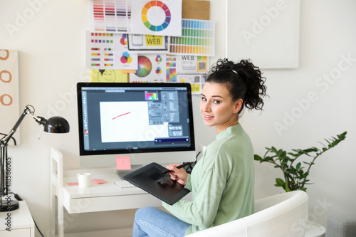 Young female designer worki...