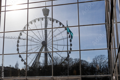 Reflection of ferris wheel in hotel windows