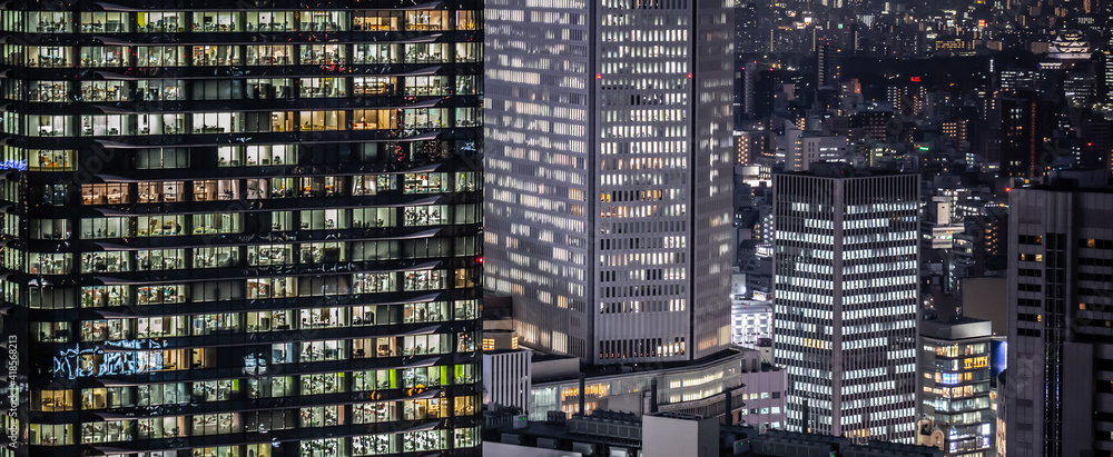 Fototapeta premium Corporate office building at night in Osaka, Japan. Late night at work