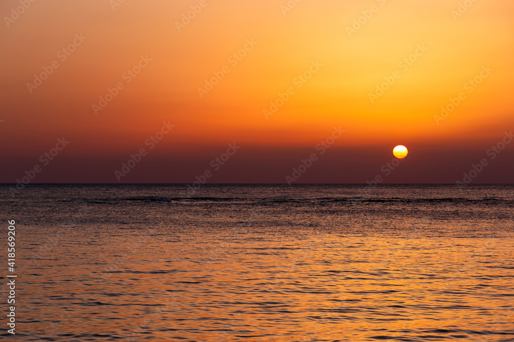 Bright sunset with a big yellow sun under the sea surface. Bright sunset with a big yellow sun under the sea surface.