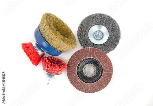 Фотография Polishing brushes and grinding discs of an angle grinder isolated on white backg