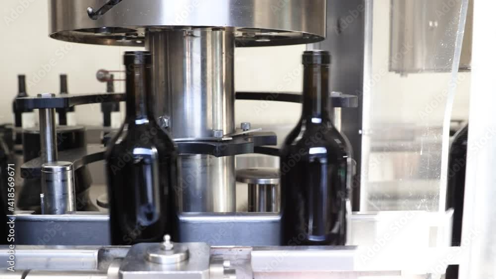 Bottles of wine being processed in bottling factory for winery Bottles of wine being processed in bottling factory for winery