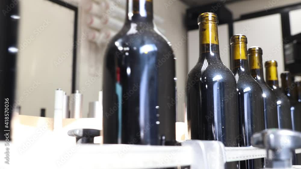 Bottles of wine being processed in bottling factory for winery Bottles of wine being processed in bottling factory for winery