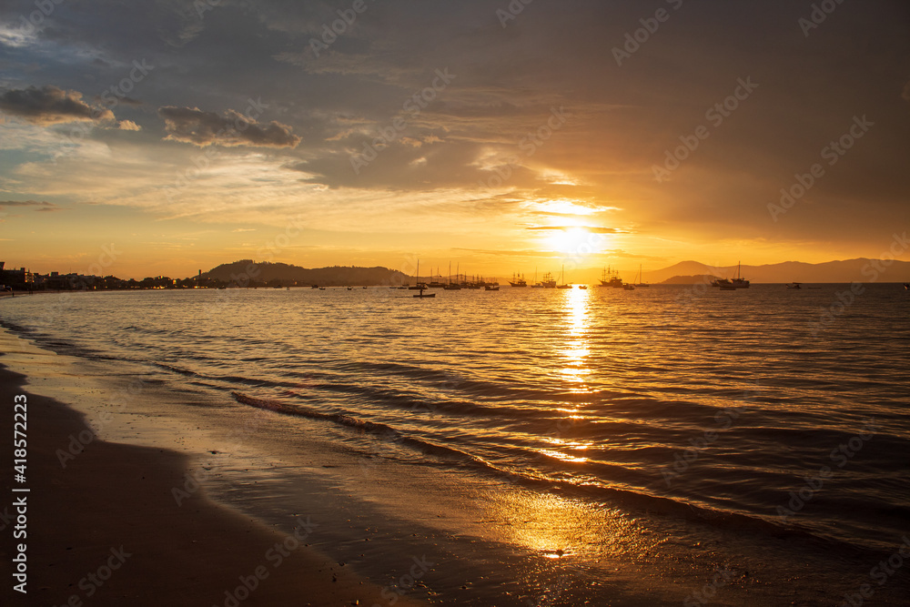 Sunset on a tropical beach with pirate boats in the background, located on the beach of Cachoeira do Bom Jesus, Canasvieras, Ponta das Canas, Florianopolis, Santa Catarina, Florianópolis, Brazil