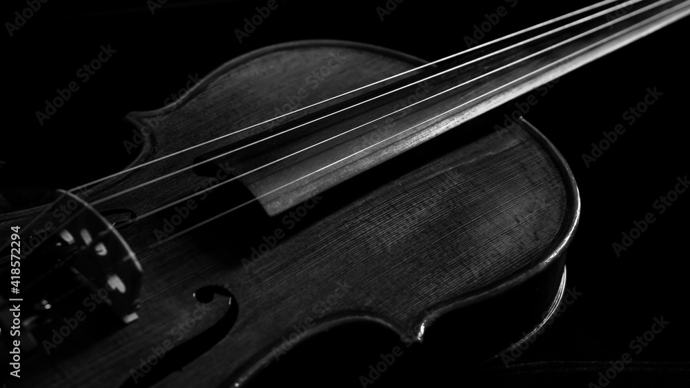 Fototapeta premium close up of a violin with dark background for copy space