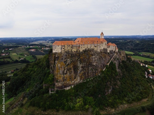 Aerial panorama view of historic old medieval castle Riegersburg on cliff top of mountain hill in Styria Austria alps photo