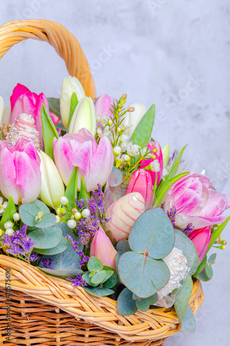 Close-up . Festive fruit basket with flowers, tulips. Concept, congratulations on the holiday, birthday, anniversary. There is a place for text