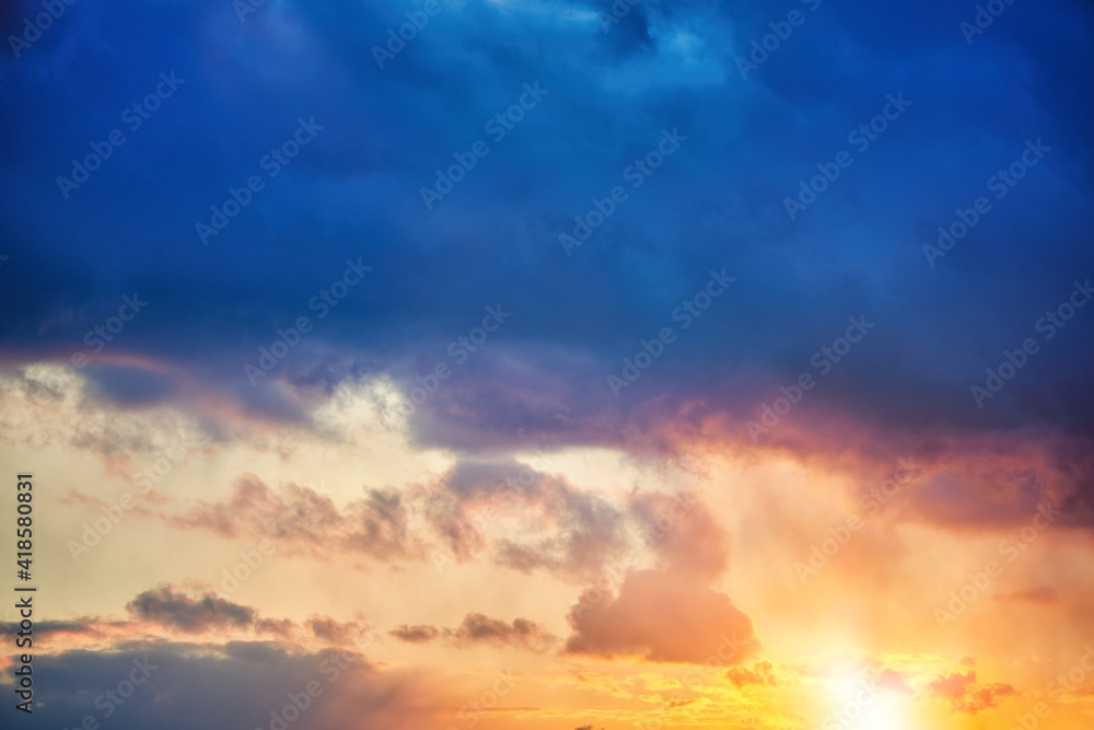 Beautiful orange, sunset or sunrise with heavy dark cloud. Colourful Glow of the evening sky