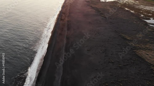 Dyrhólaey / Dyrholaey view point and its surrounding from an aerial drone 4k point of view, around the endless black sand beach during sunset, part6 