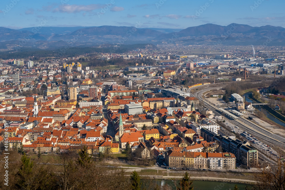 Fototapeta premium Aerial view to the city Celje in Slovenia. Red roofs, river and the bridge. Outdoor travel background.