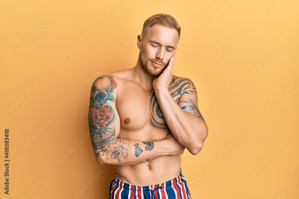 Fototapeta premium Young caucasian man wearing swimwear shirtless thinking looking tired and bored with depression problems with crossed arms.